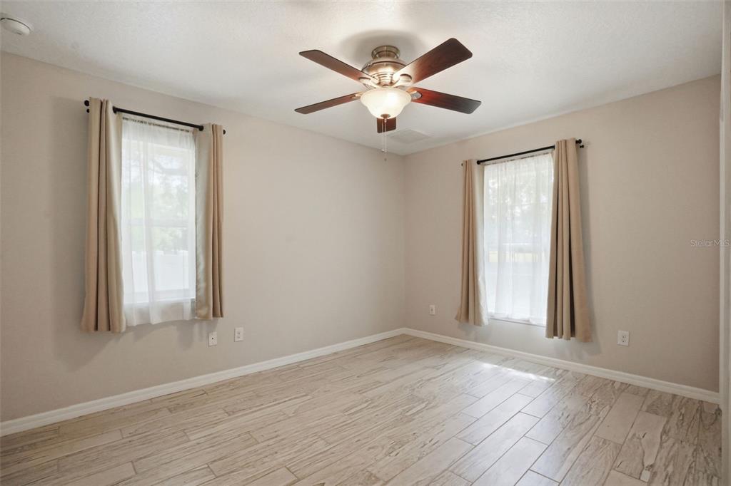 7037 County Road 625 Bushnell, FL 33513 - Photo 51 of 99 a view of an empty room with wooden floor and a window