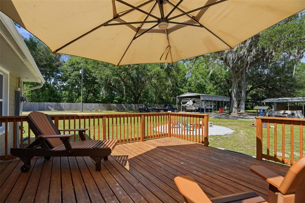 7037 County Road 625 Bushnell, FL 33513 - Photo 55 of 99 a view of balcony with hardwood floor and outdoor seating