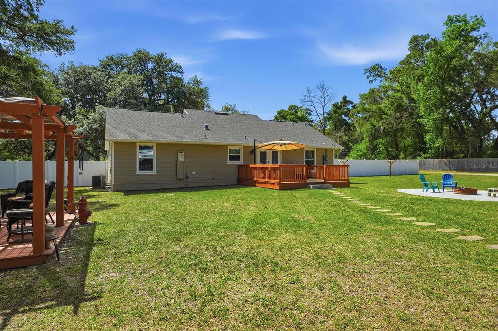 7037 County Road 625 Bushnell, FL 33513 - Photo 58 of 99 a view of a house with backyard and sitting area