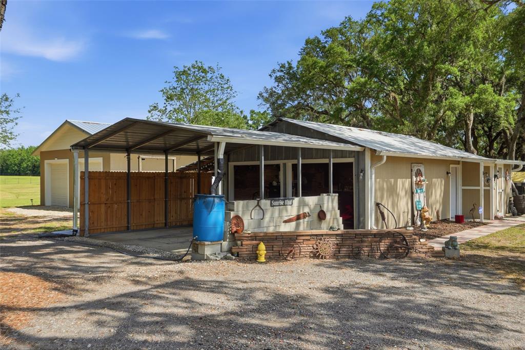 7037 County Road 625 Bushnell, FL 33513 - Photo 66 of 99 a front view of a house with a garden and porch