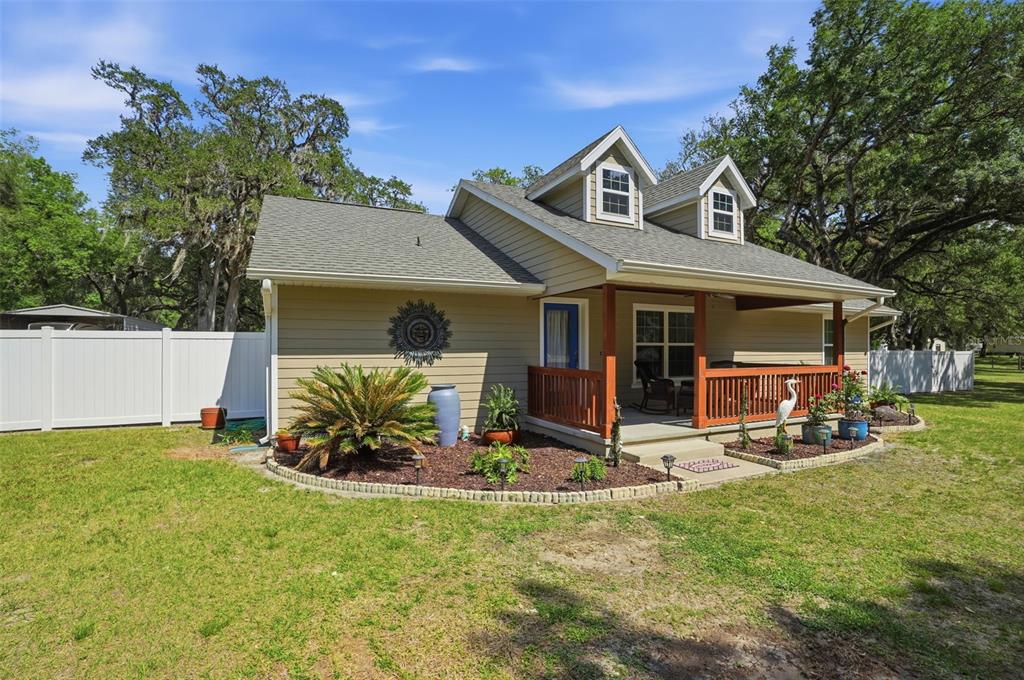 7037 County Road 625 Bushnell, FL 33513 - Photo 79 of 99 a view of a house with backyard porch and sitting area