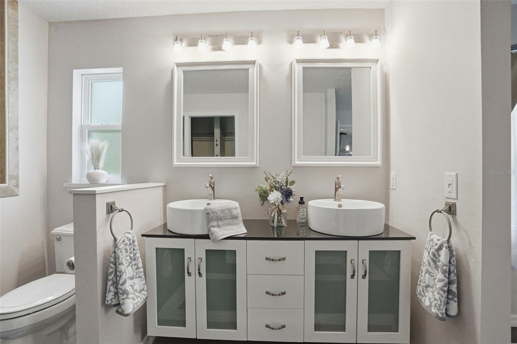 7037 County Road 625 Bushnell, FL 33513 - Photo 8 of 99 a bathroom with a granite countertop toilet sink and mirror
