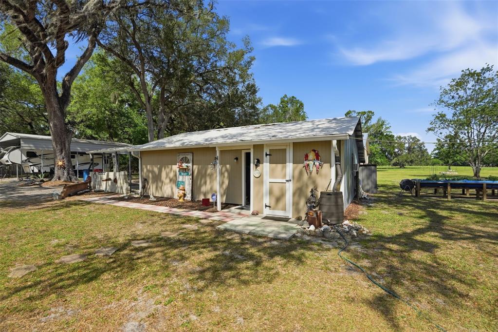7037 County Road 625 Bushnell, FL 33513 - Photo 87 of 99 a view of a house with swimming pool and sitting area