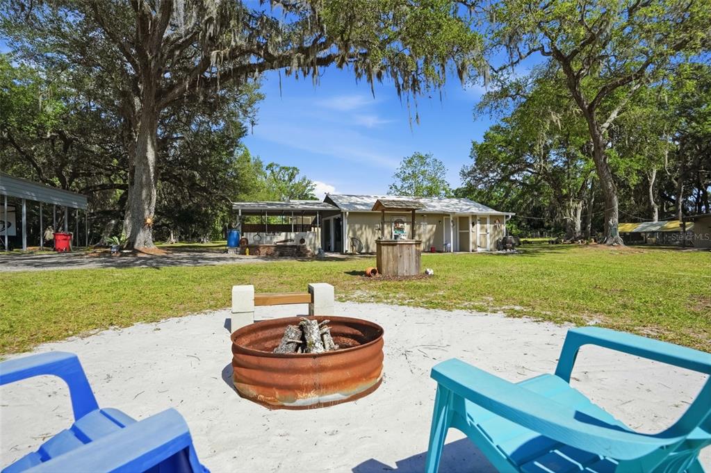7037 County Road 625 Bushnell, FL 33513 - Photo 94 of 99 a front view of a house with a yard table and chairs