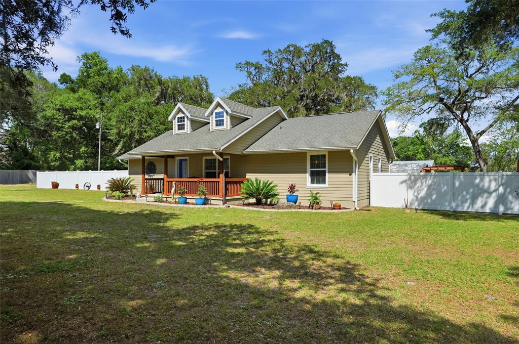 7037 County Road 625 Bushnell, FL 33513 - Photo 99 of 99 a front view of a house with garden