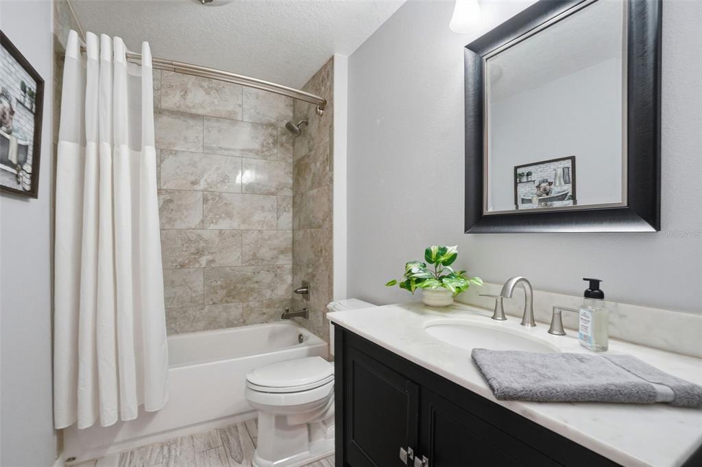 7037 County Road 625 Bushnell, FL 33513 - Photo 10 of 99 a bathroom with a granite countertop sink toilet and shower