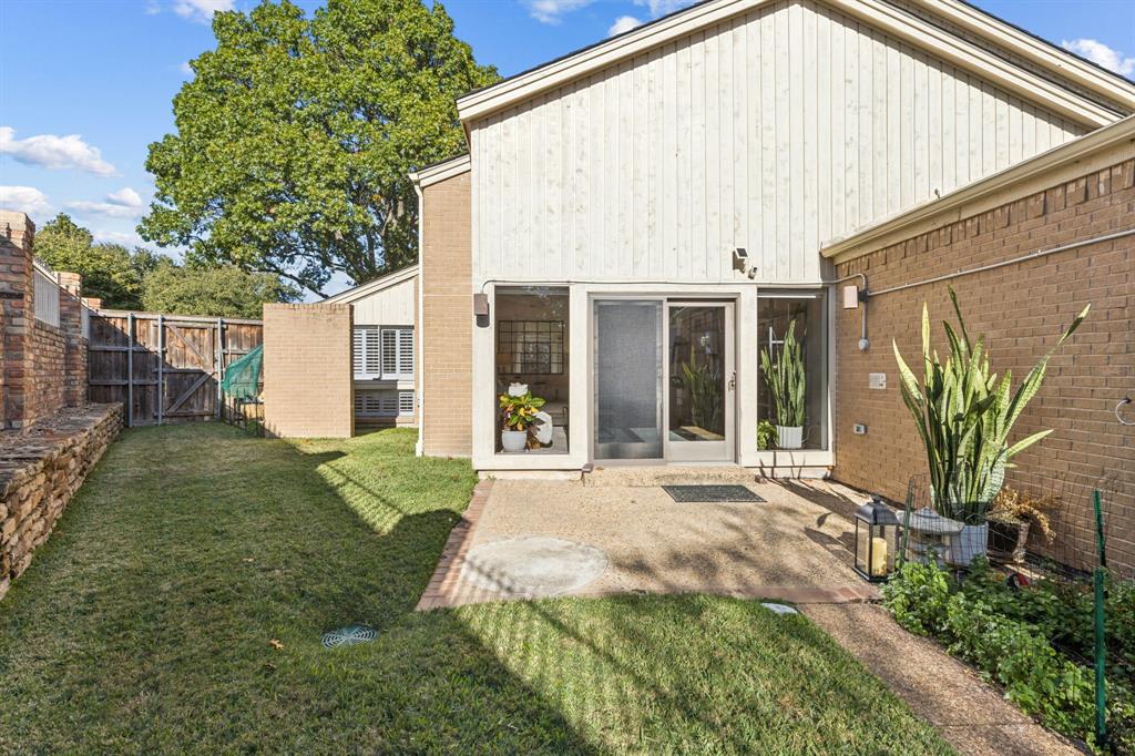 9616 Viewside Drive Dallas, TX 75231 - Photo 29 of 38 Rear view of house featuring a gate, a fenced backyard, a patio, and brick siding