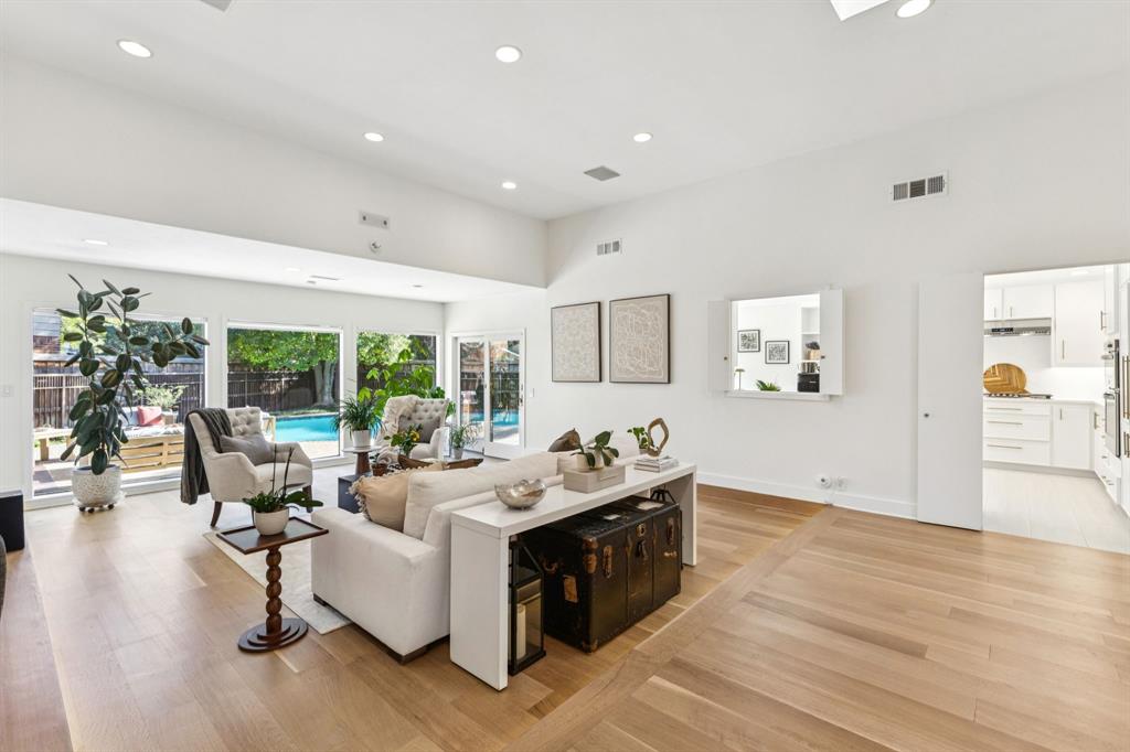 9616 Viewside Drive Dallas, TX 75231 - Photo 4 of 38 Living room featuring light wood-type flooring, recessed lighting, and a towering ceiling