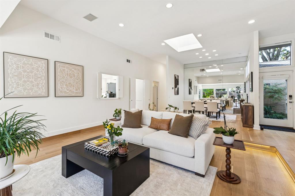 9616 Viewside Drive Dallas, TX 75231 - Photo 5 of 38 Living room featuring a skylight, recessed lighting, and light wood-style floors
