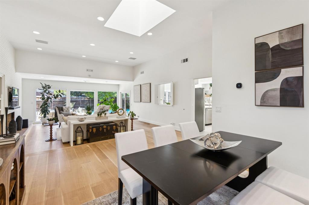 9616 Viewside Drive Dallas, TX 75231 - Photo 6 of 38 Dining area with a skylight, wood finished floors, recessed lighting, and a high ceiling