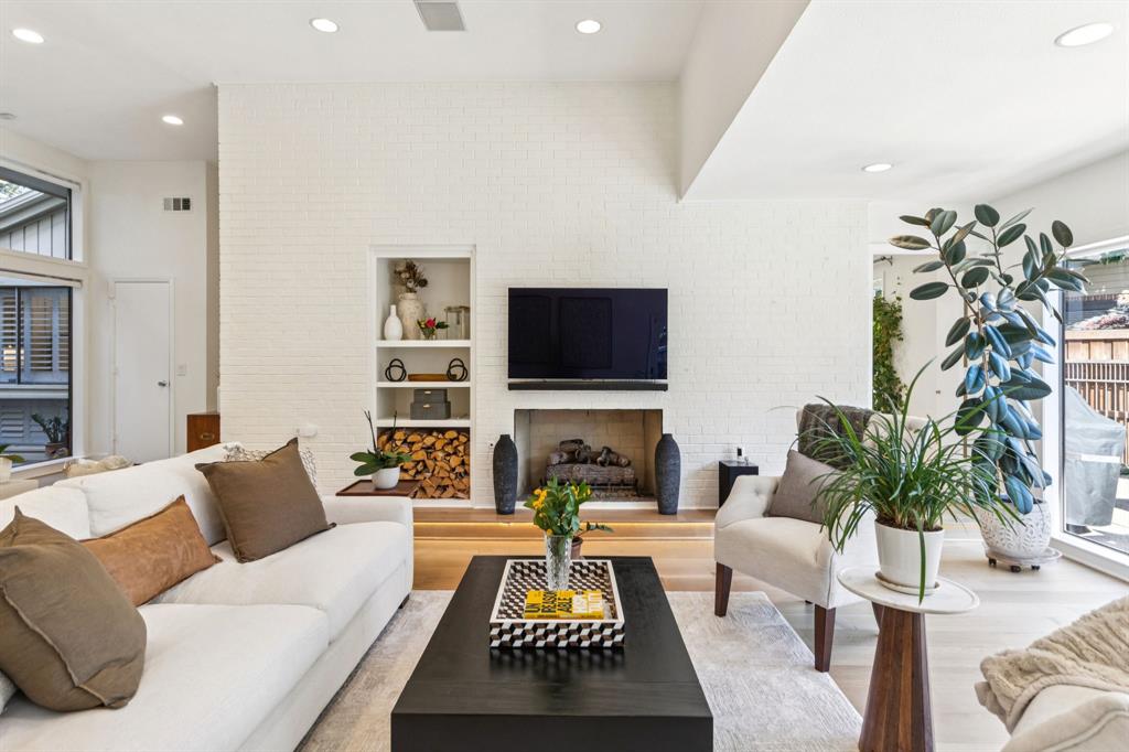 9616 Viewside Drive Dallas, TX 75231 - Photo 9 of 38 Living area with a fireplace, healthy amount of natural light, wood finished floors, recessed lighting, and built in features