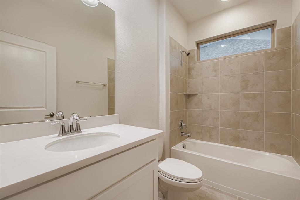 312 Magnolia Drive Oak Point, TX 75068 - Photo 20 of 28 Bathroom featuring bathtub / shower combination, vanity, and light tile patterned floors