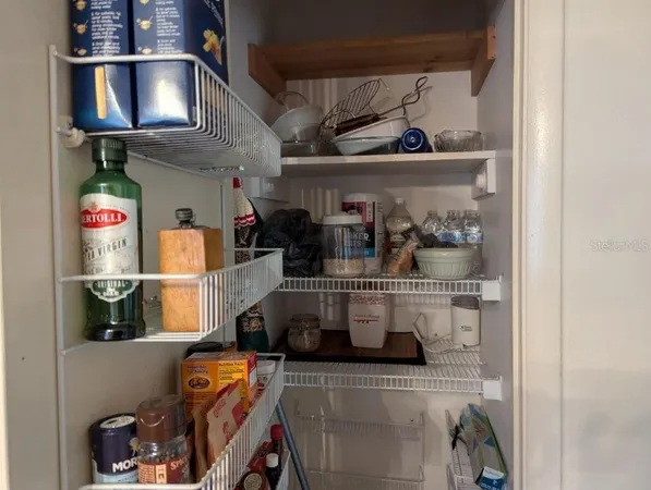 a view of a room with wooden floor and windows
