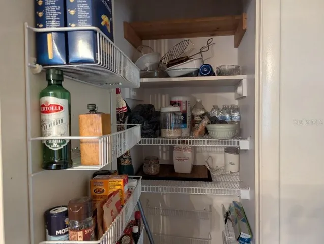 a view of a room with wooden floor and windows