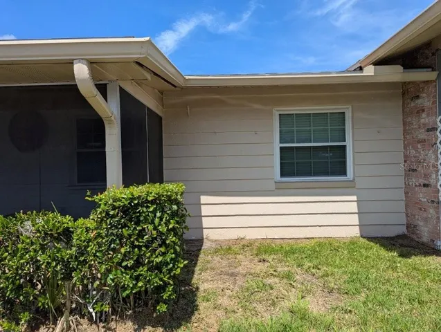 a car parked in front of a white house