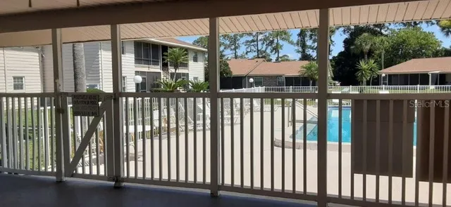 a view of a patio with table and chairs next to a yard