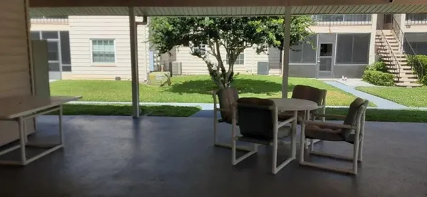a bathroom with a toilet and a chair