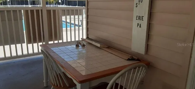 a view of a porch with chairs and a yard