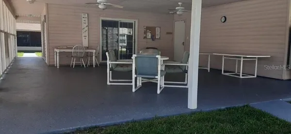 a view of a patio with swimming pool table and chairs