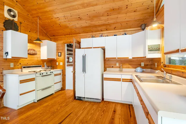 a outdoor dining space with a table and chairs