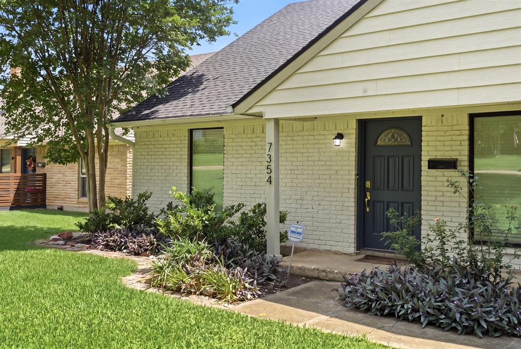7354 Walling Lane Dallas, TX 75231 - Photo 3 of 28 a front view of a house with garden