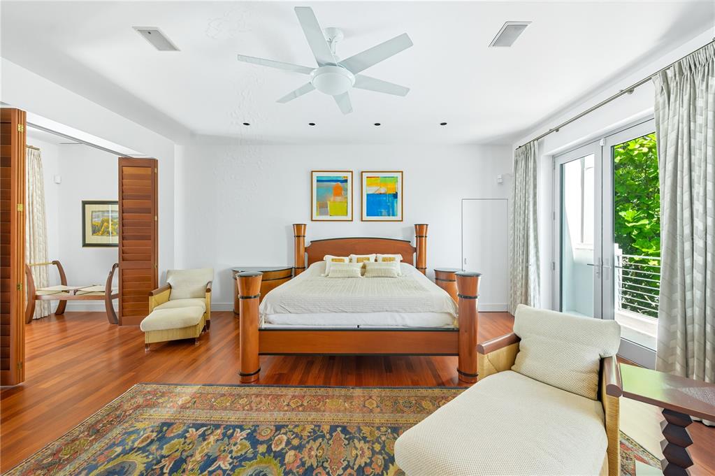 3315 Bay Shore Road Sarasota, FL 34234 - Photo 40 of 96 a bedroom with a bed and wooden floor