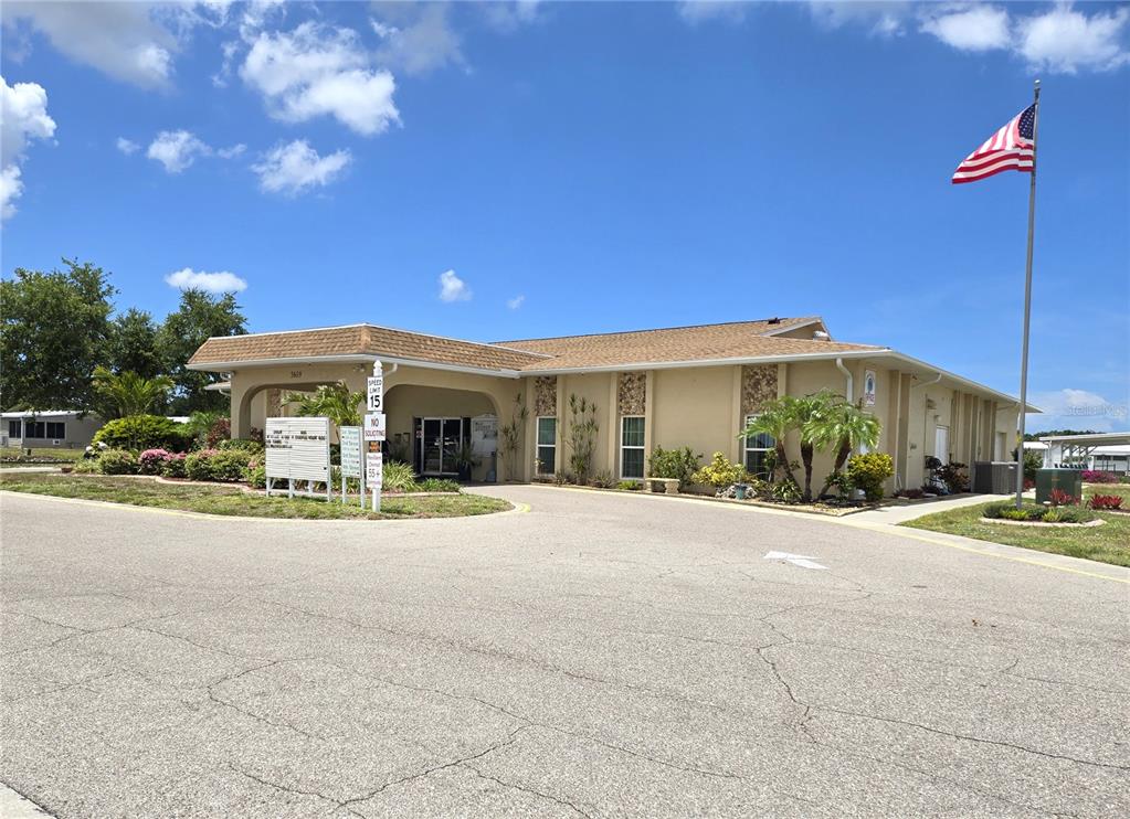 5619 Bayshore Road, Unit 435 Palmetto, FL 34221 - Photo 46 of 56 a view of a building with a yard and potted plants