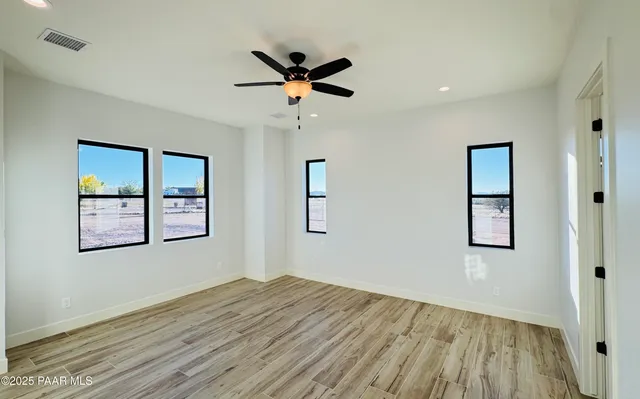 a bathroom with a granite countertop sink a mirror and shower