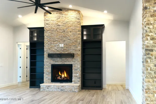a view of a livingroom with a fireplace and wooden floor