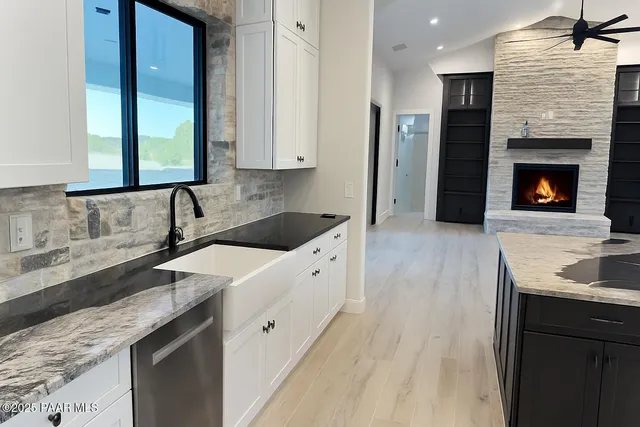 a kitchen with granite countertop a sink and a stove