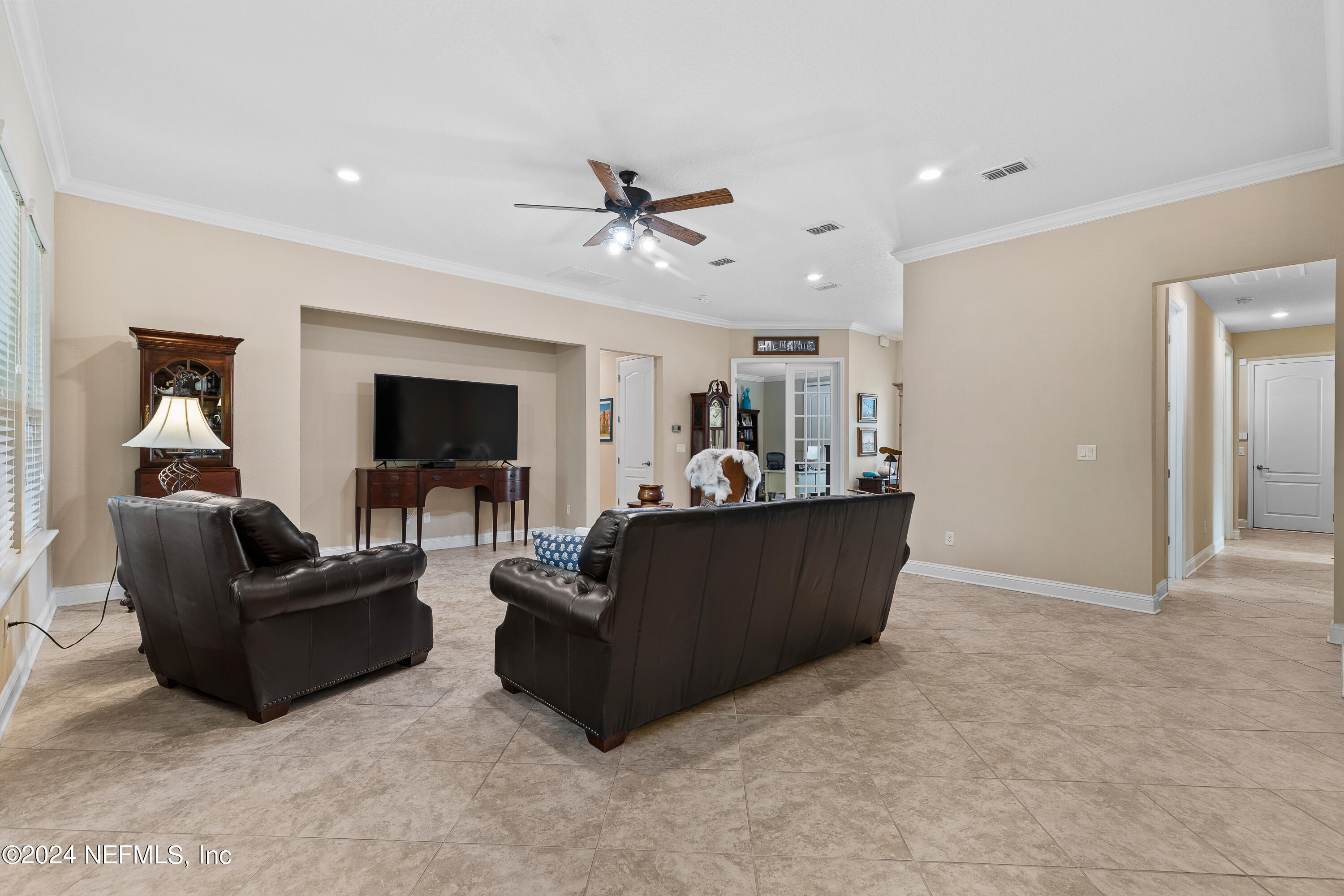 405 St Kitts Loop St. Augustine, FL 32092 - Photo 13 of 65 a living room with furniture and a flat screen tv