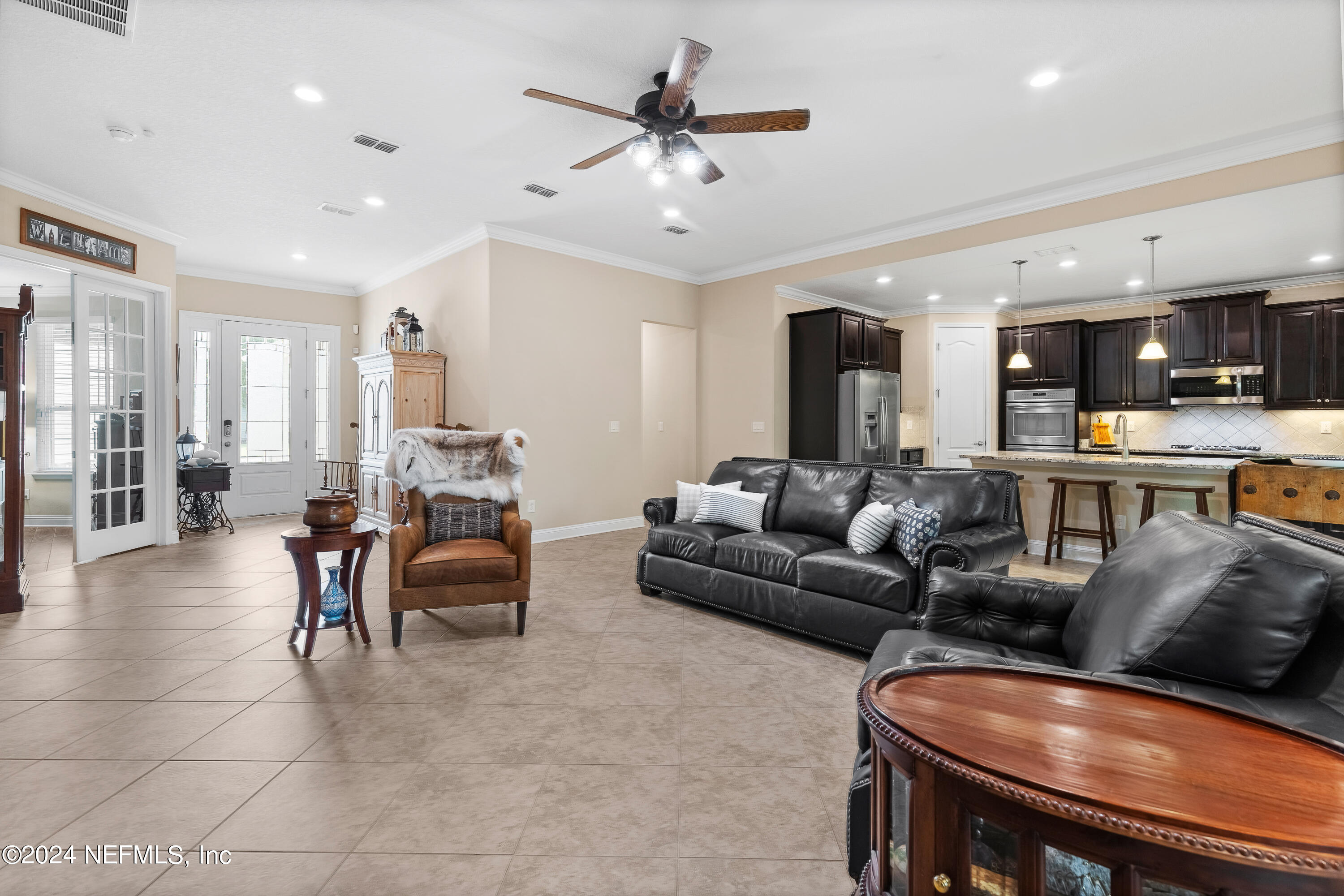 405 St Kitts Loop St. Augustine, FL 32092 - Photo 14 of 65 a living room with furniture kitchen view and a chandelier
