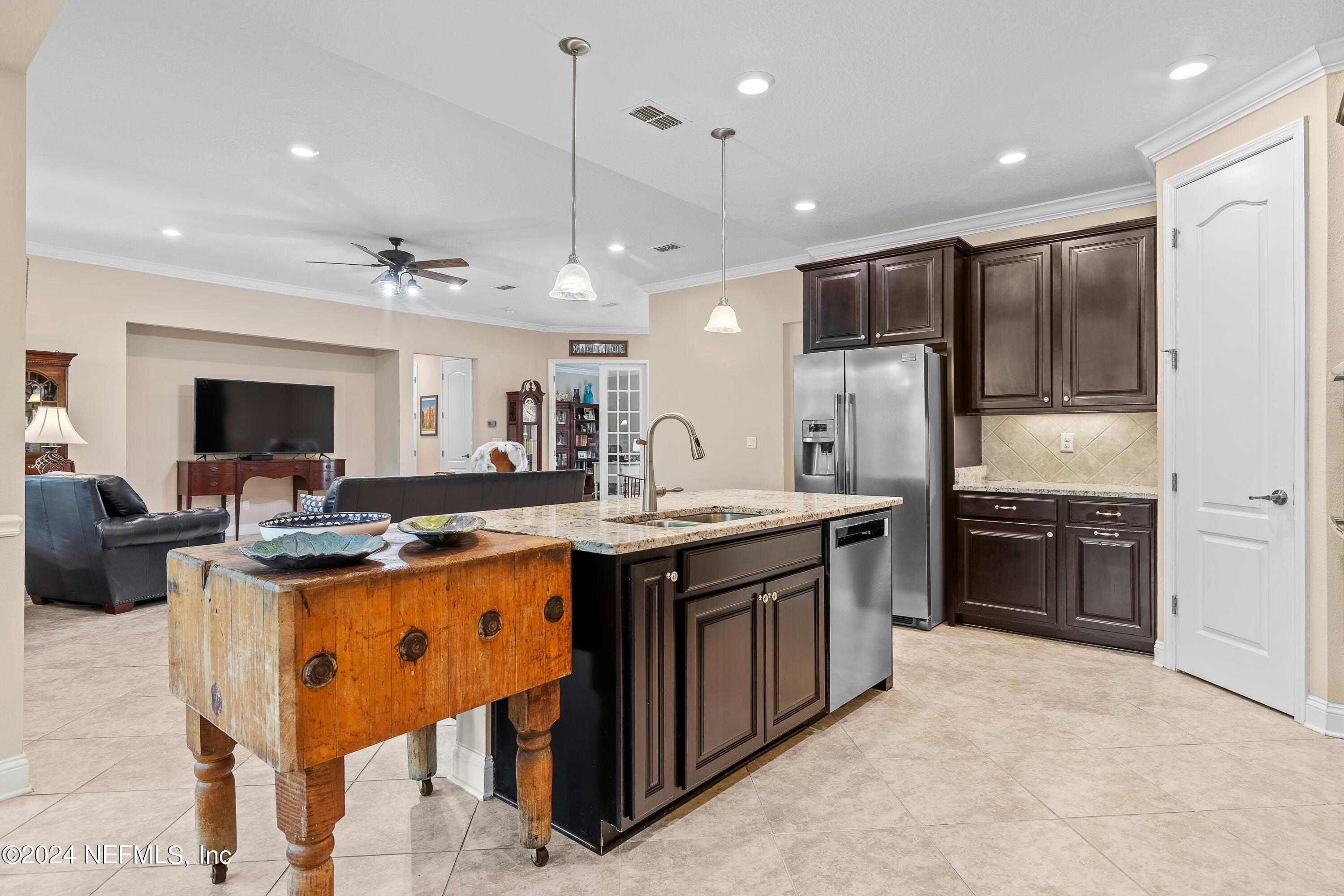 405 St Kitts Loop St. Augustine, FL 32092 - Photo 19 of 65 a kitchen with stainless steel appliances granite countertop a stove refrigerator and a sink