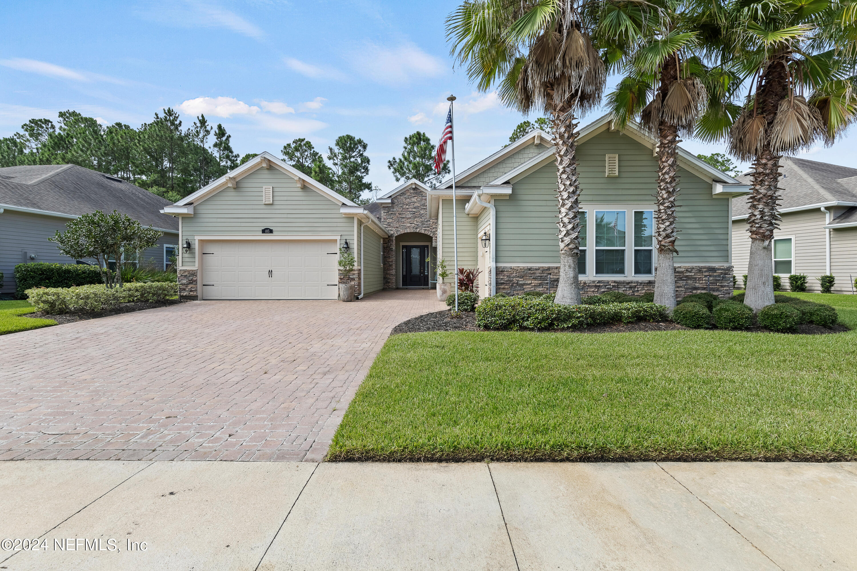 405 St Kitts Loop St. Augustine, FL 32092 - Photo 2 of 65 a front view of a house with a yard and garage
