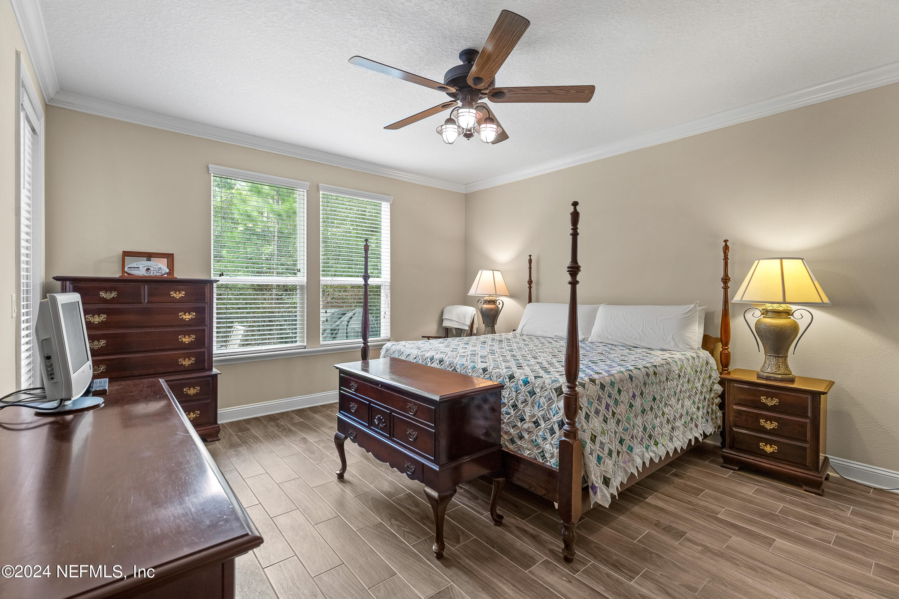 405 St Kitts Loop St. Augustine, FL 32092 - Photo 23 of 65 a bedroom with a bed and dresser with wooden floor