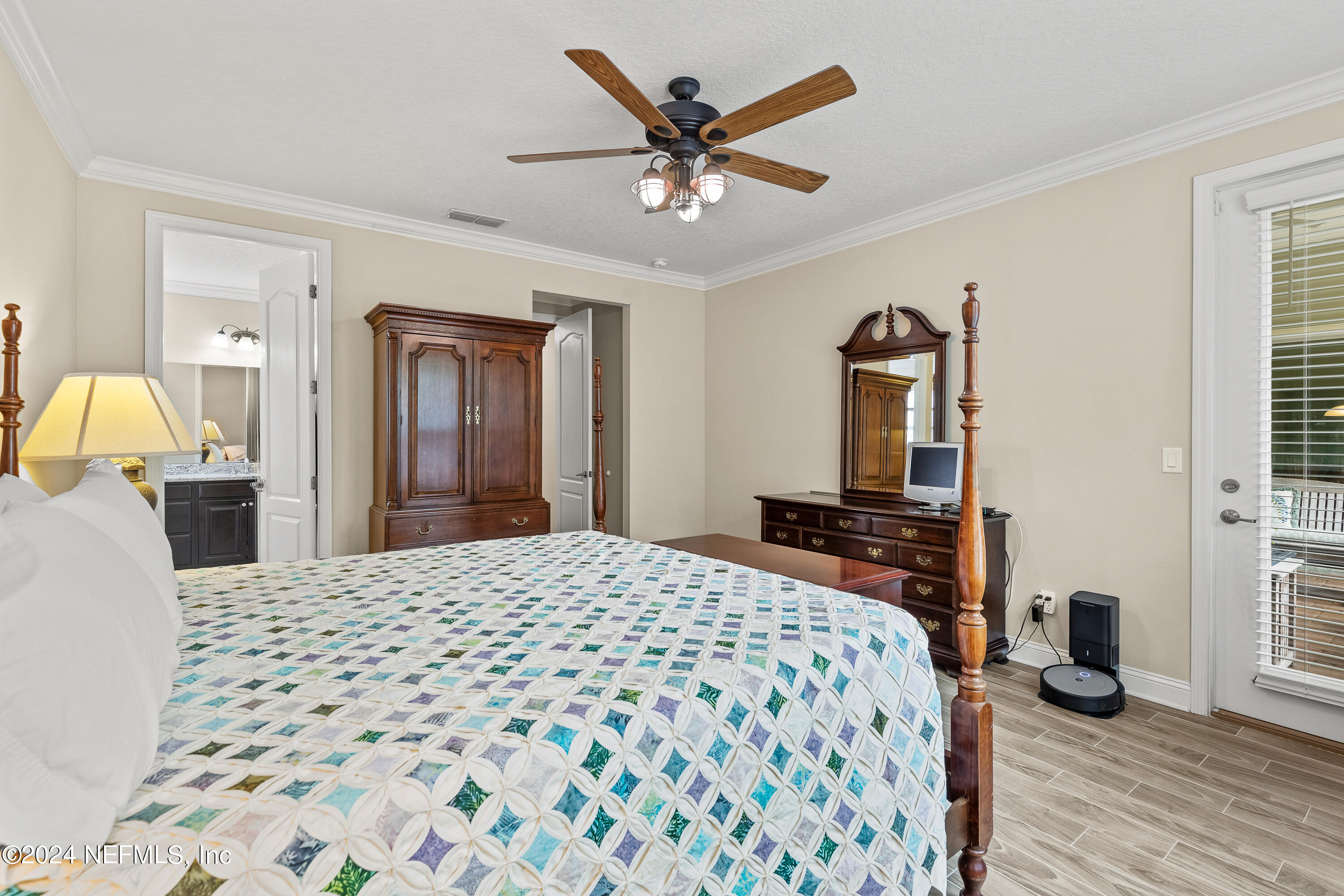 405 St Kitts Loop St. Augustine, FL 32092 - Photo 25 of 65 a bedroom with a bed and a dresser with wooden floor