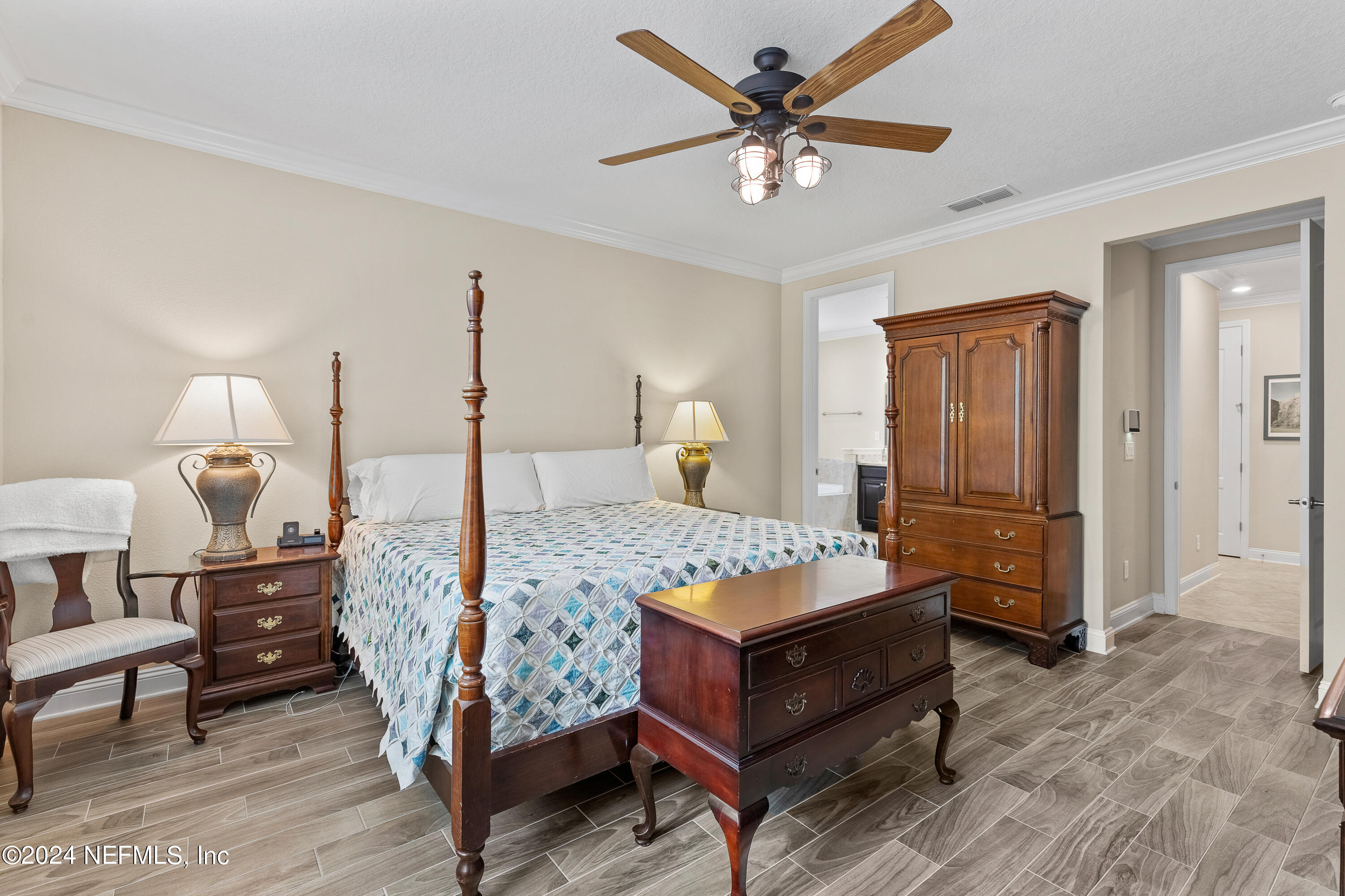 405 St Kitts Loop St. Augustine, FL 32092 - Photo 26 of 65 a bedroom with a bed a table and painting on the wall