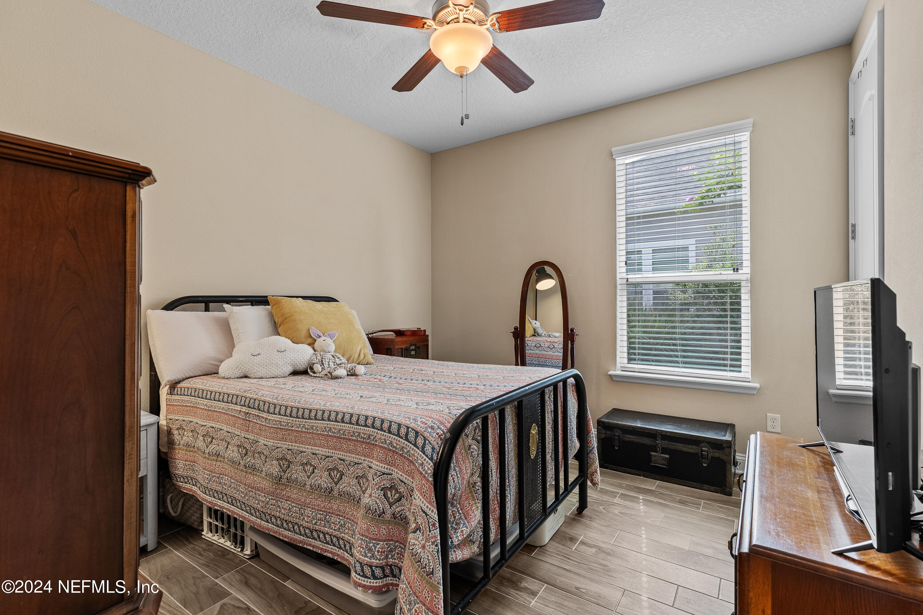 405 St Kitts Loop St. Augustine, FL 32092 - Photo 33 of 65 a bedroom with a bed and a flat tv screen on dresser