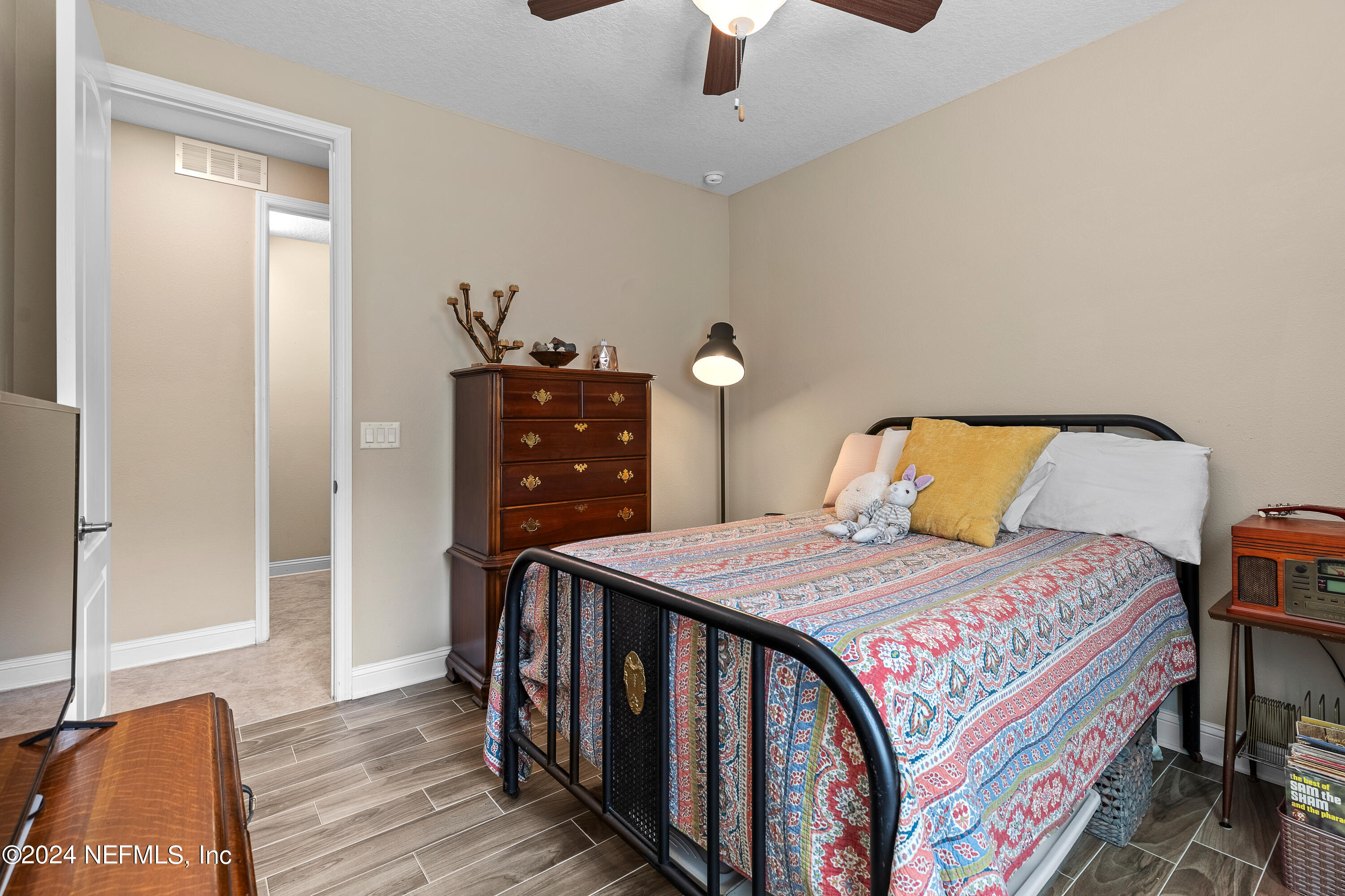 405 St Kitts Loop St. Augustine, FL 32092 - Photo 34 of 65 a bedroom with a bed and wooden floor