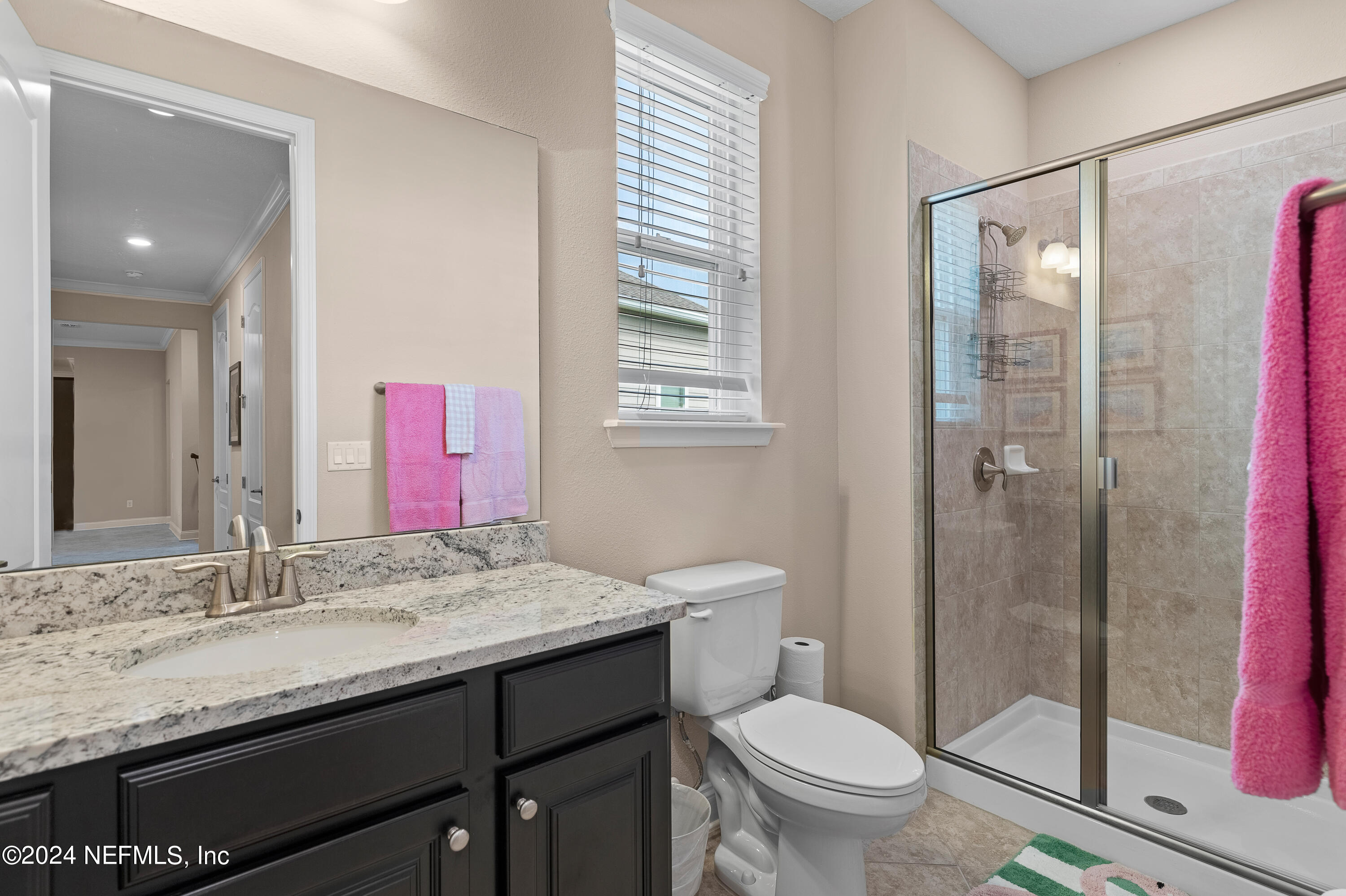 405 St Kitts Loop St. Augustine, FL 32092 - Photo 35 of 65 a bathroom with a granite countertop sink toilet and shower