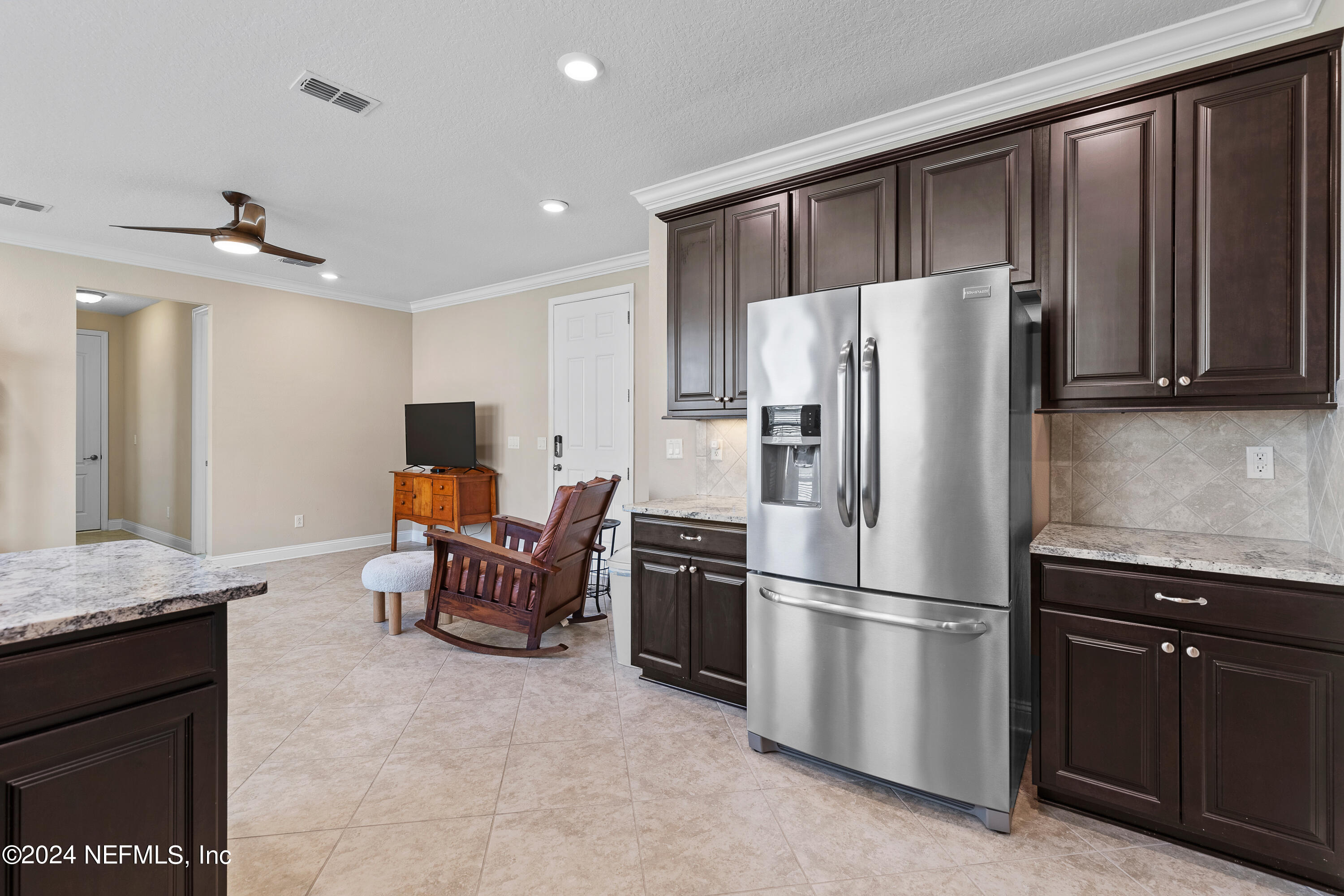 405 St Kitts Loop St. Augustine, FL 32092 - Photo 40 of 65 a kitchen with stainless steel appliances granite countertop a refrigerator a stove a sink and a refrigerator
