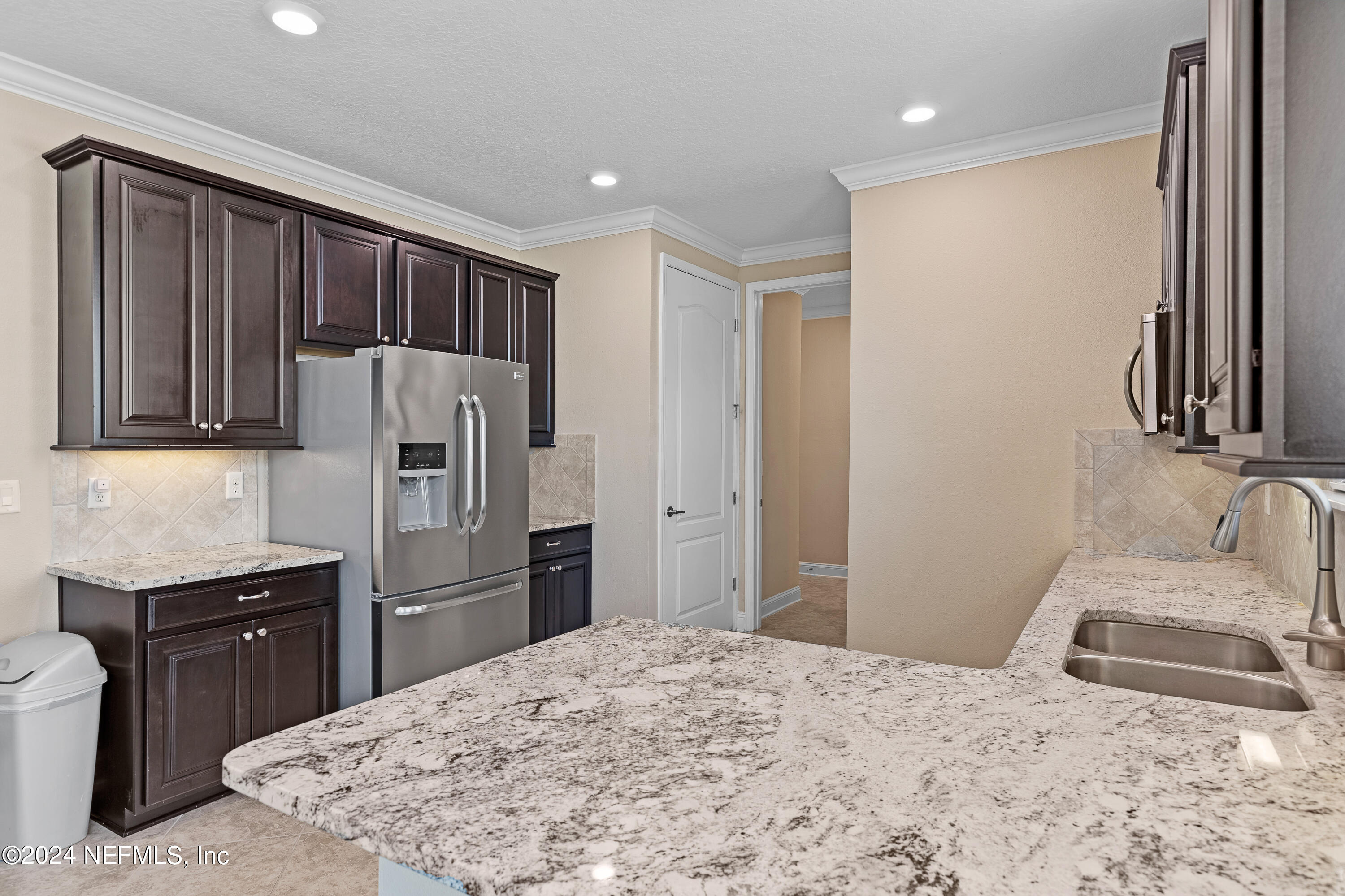 405 St Kitts Loop St. Augustine, FL 32092 - Photo 41 of 65 a kitchen with a refrigerator and a sink