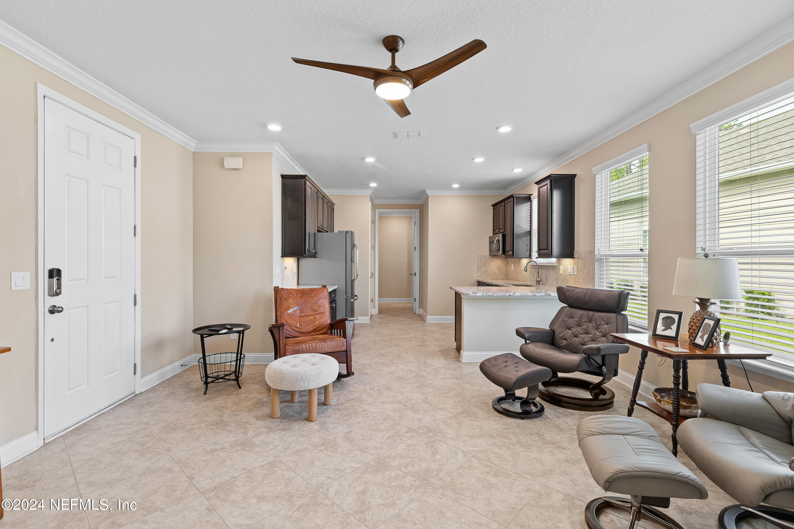 405 St Kitts Loop St. Augustine, FL 32092 - Photo 44 of 65 a living room with furniture a ceiling fan and a window