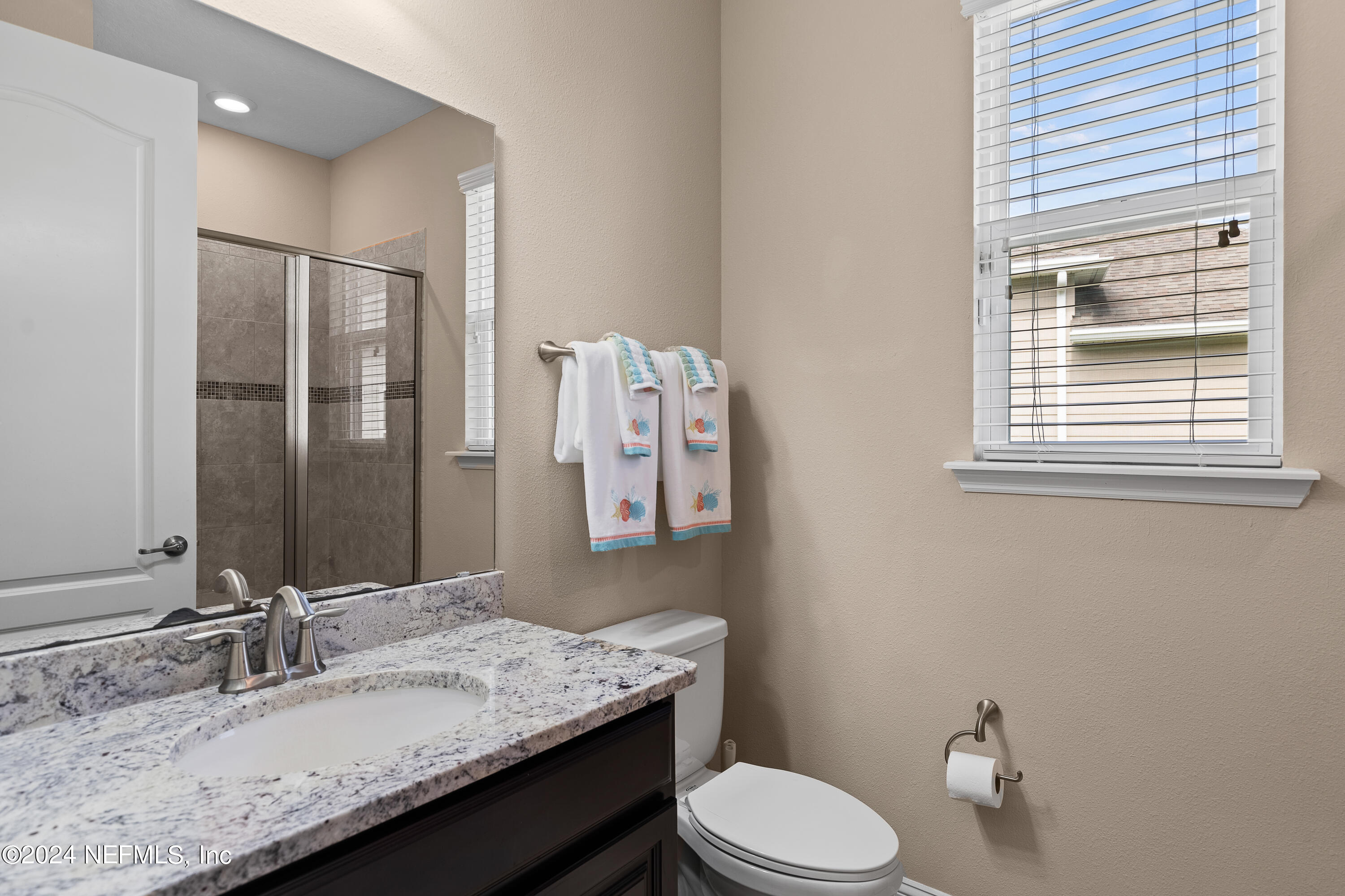 405 St Kitts Loop St. Augustine, FL 32092 - Photo 45 of 65 a bathroom with a granite countertop sink mirror vanity and toilet
