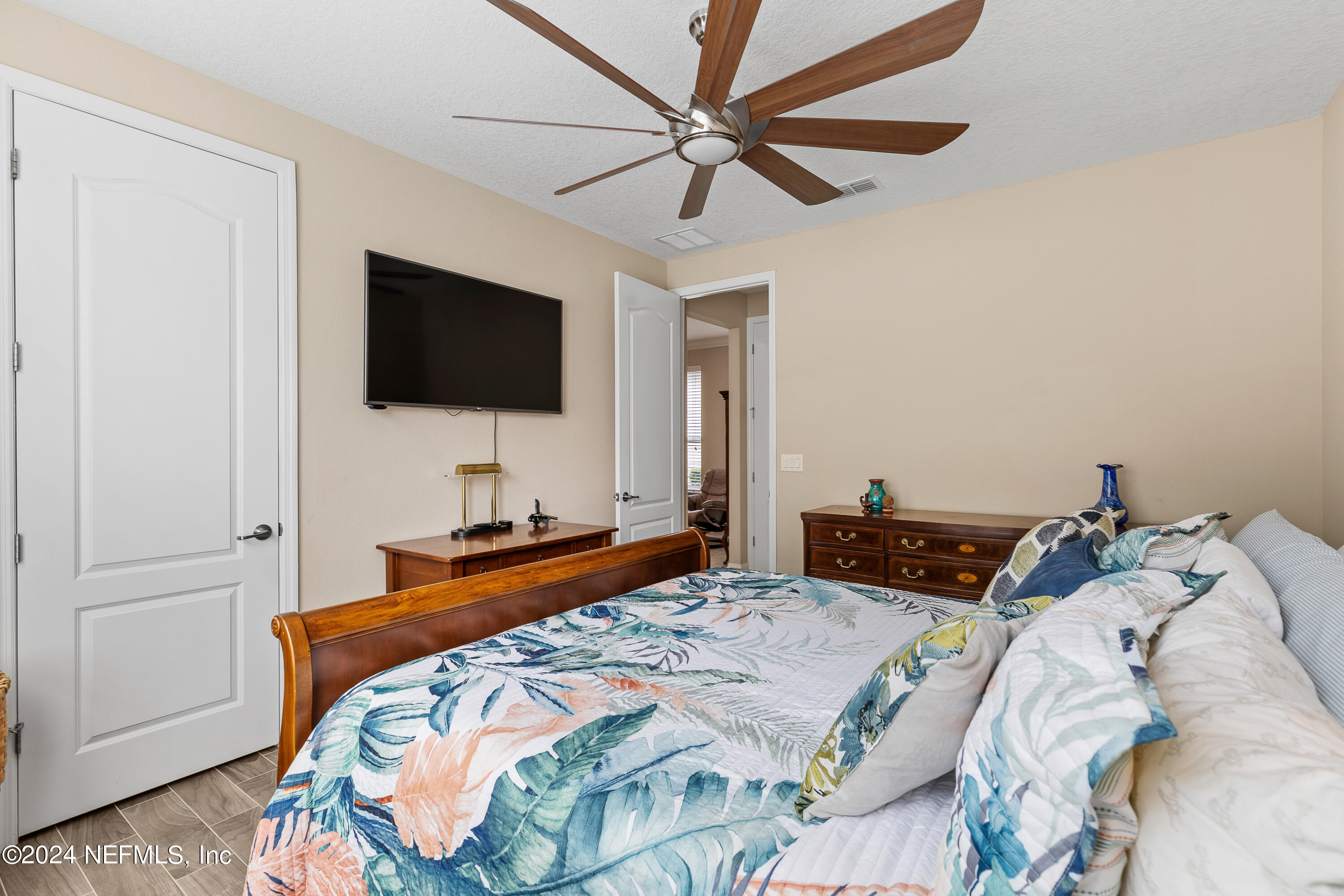 405 St Kitts Loop St. Augustine, FL 32092 - Photo 48 of 65 a bedroom with a bed and a flat screen tv