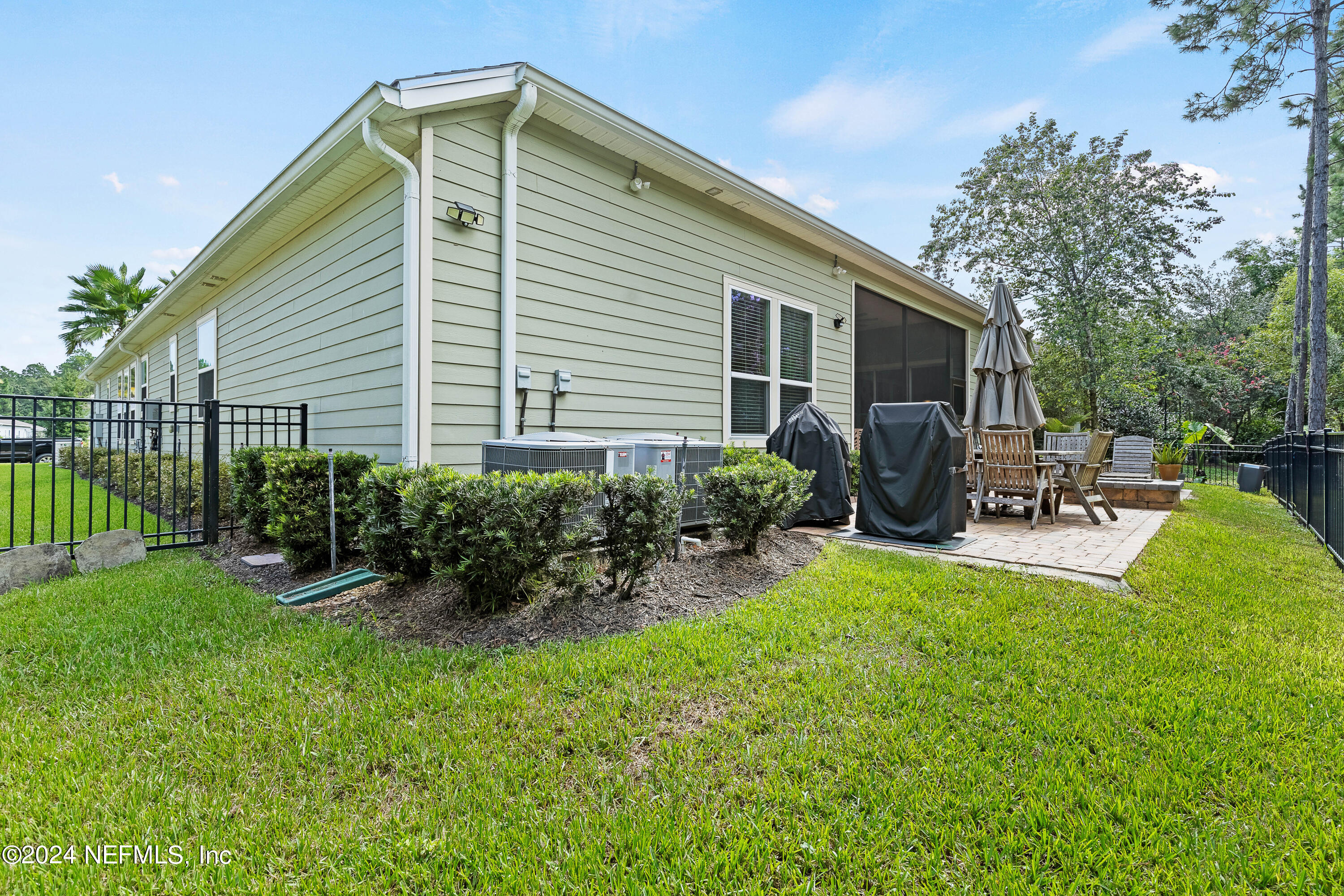 405 St Kitts Loop St. Augustine, FL 32092 - Photo 53 of 65 a view of backyard of house with outdoor seating and green space