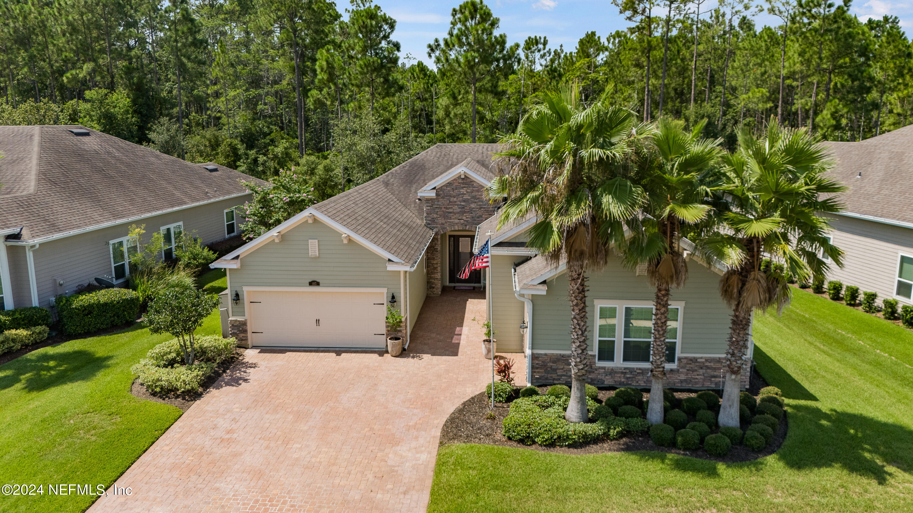 405 St Kitts Loop St. Augustine, FL 32092 - Photo 60 of 65 a front view of a house with a garden