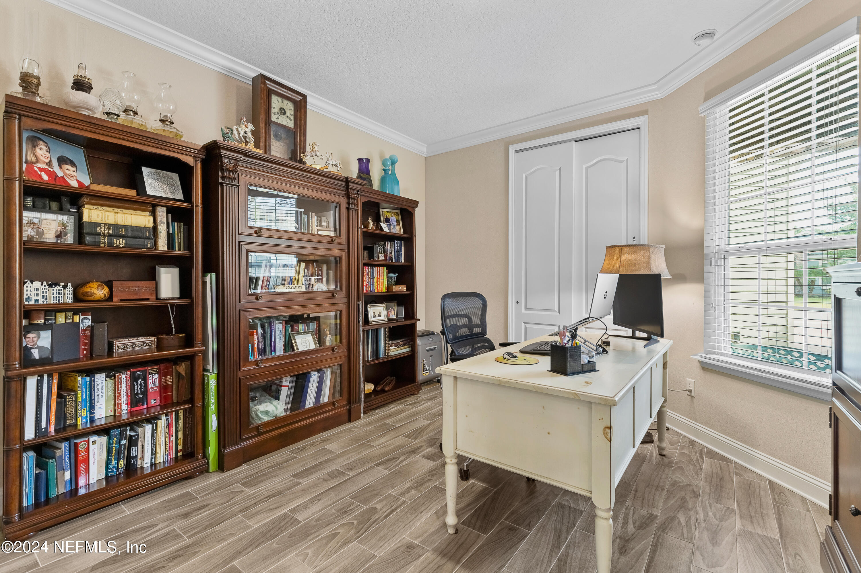 405 St Kitts Loop St. Augustine, FL 32092 - Photo 9 of 65 a work room with furniture bookshelf and a window