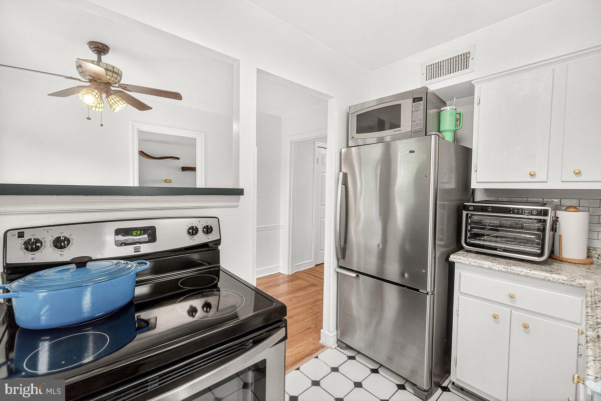 22 Norva Avenue Frederick, MD 21701 - Photo 12 of 37 a kitchen with stainless steel appliances a stove a refrigerator and cabinets