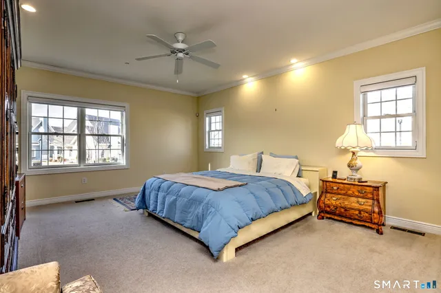 a spacious bedroom with a bed and a chandelier